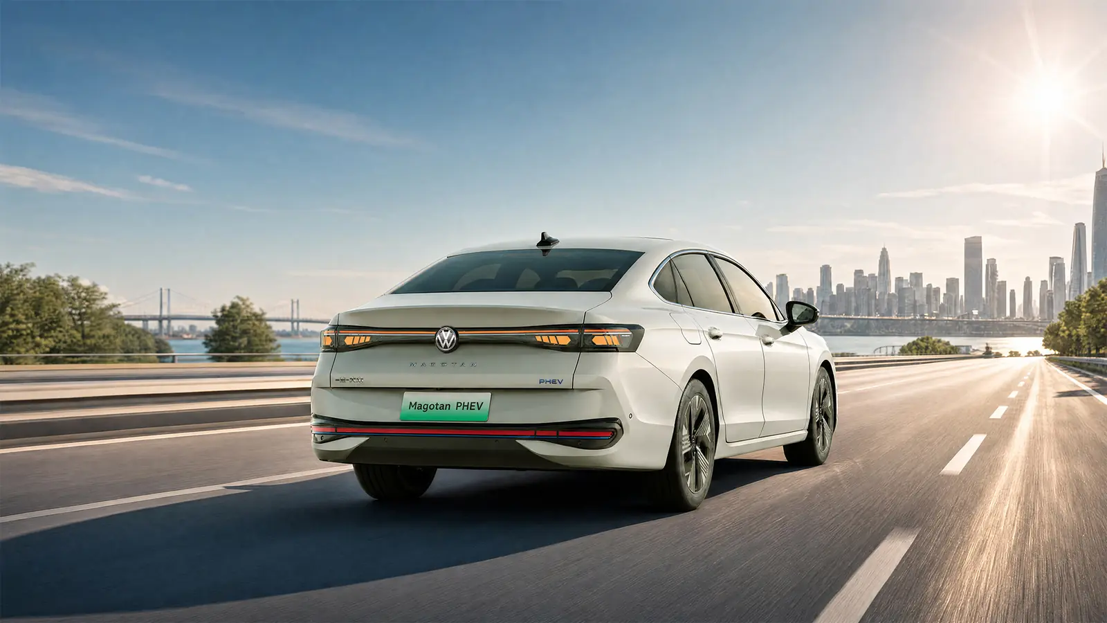 Magotan PHEV rear view on a highway at sunset
